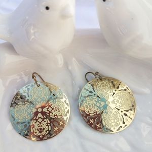 Gold and cream colored earrings